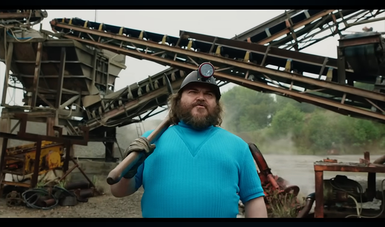 Le personnage Steve avec une chemise bleue et plusieurs bâtiments en arrière-plan.